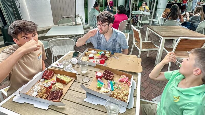 Three boys enjoy mouthfuls of cake last year at Loop It Up's inaugural Cake Party. The second...