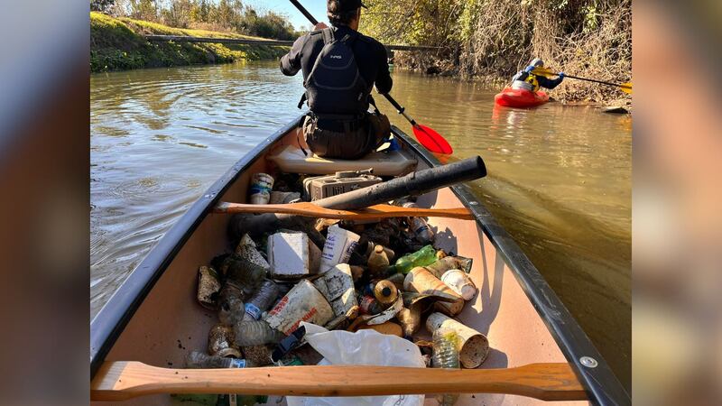 Team Moonbird volunteers clean trash from canal near Enmarket Arena.