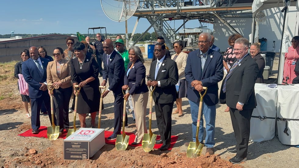 Airport leaders pose before the time capsule is buried on Stogner Hill